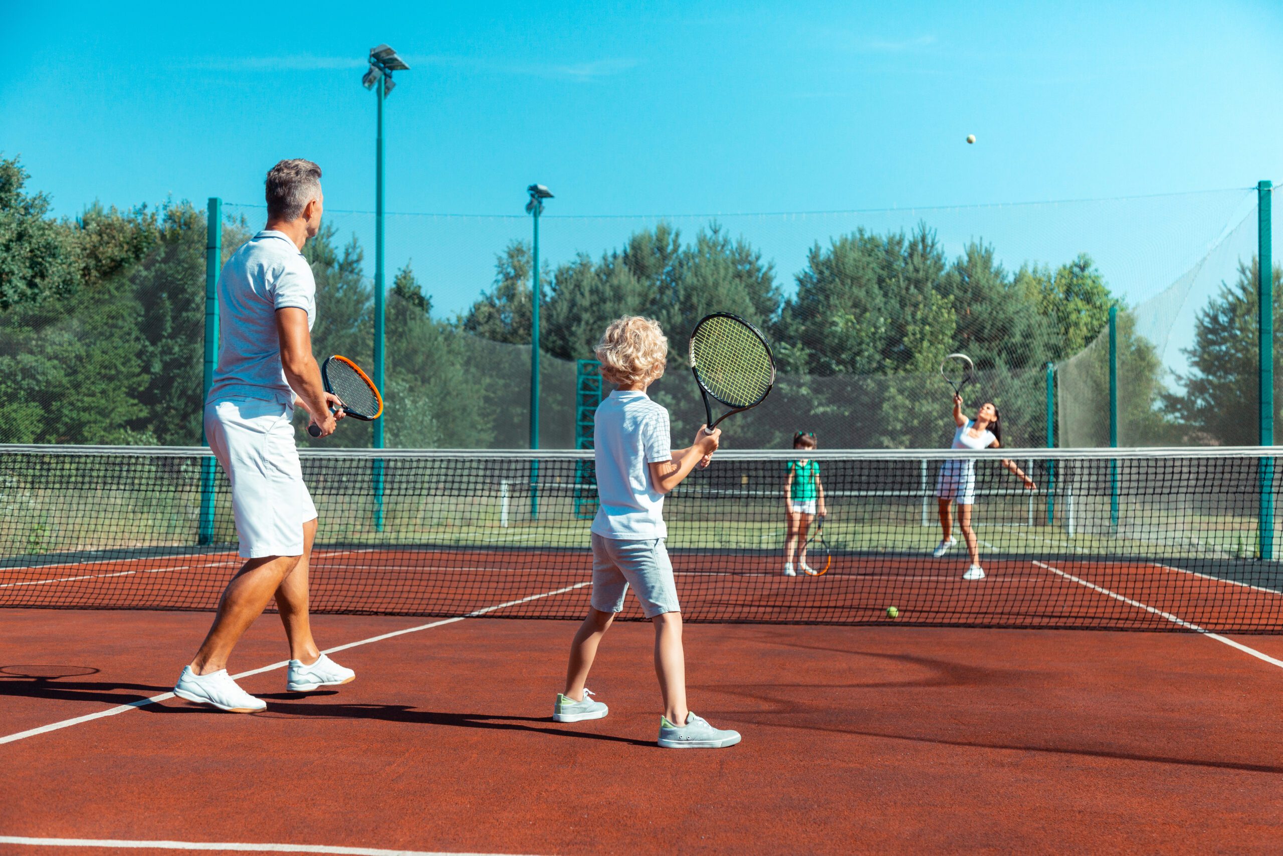 Family,Game.,Father,And,Son,Feeling,Involved,In,Playing,Tennis