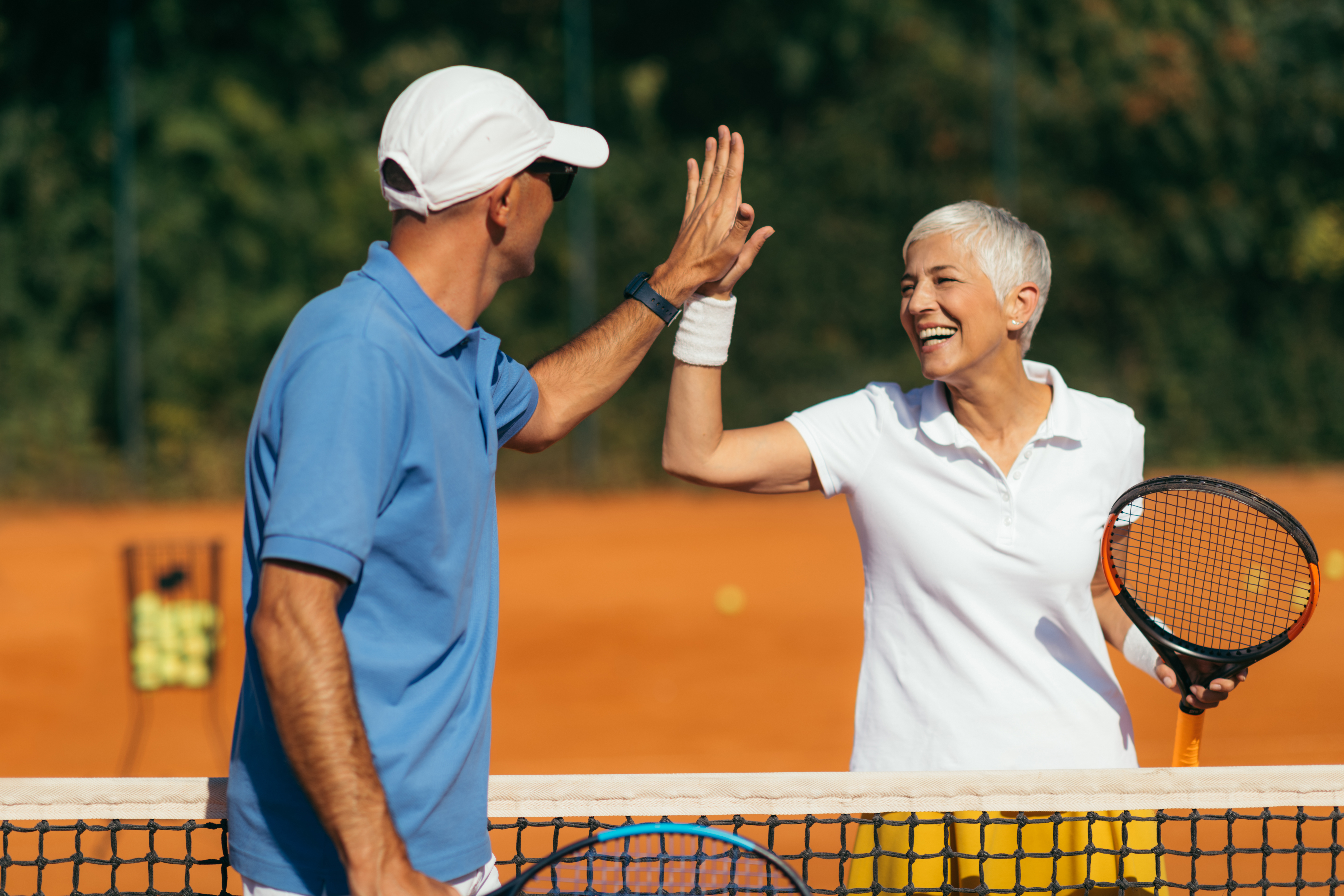 Tennis,Coach,Practicing,Service,With,Senior,Woman,On,Outdoor,Tennis